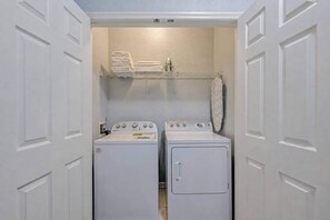 A laundry room with two washing machines and a drying rack. - Vista Cay 3BR Condo • Pools • Near Universal (Orlando)