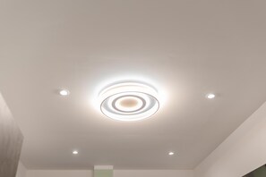 A ceiling with a central circular light fixture and four smaller lights around it. - Maison Tresor by Wonderful Italy (Turin)