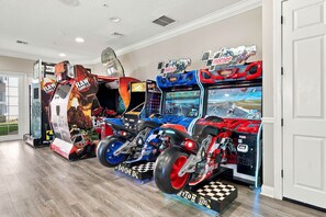 A row of arcade racing games with racing motorcycles as decorations. - Vista Cay 3BR, Comfort & Prime Location, Sleeps 7 (Orlando)