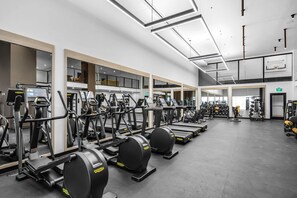 A gym with various cardio machines, weightlifting equipment, and a basketball court. - Miami Escape 1807 for 4 (Miami)