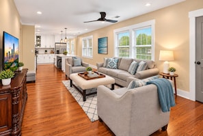 A spacious living room with a sofa set, a coffee table, and a TV.
