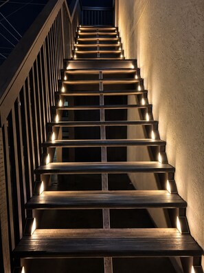 A staircase with illuminated handrails and steps, leading upwards. - Downtown Venice Island | private patio, walkable (Venice)