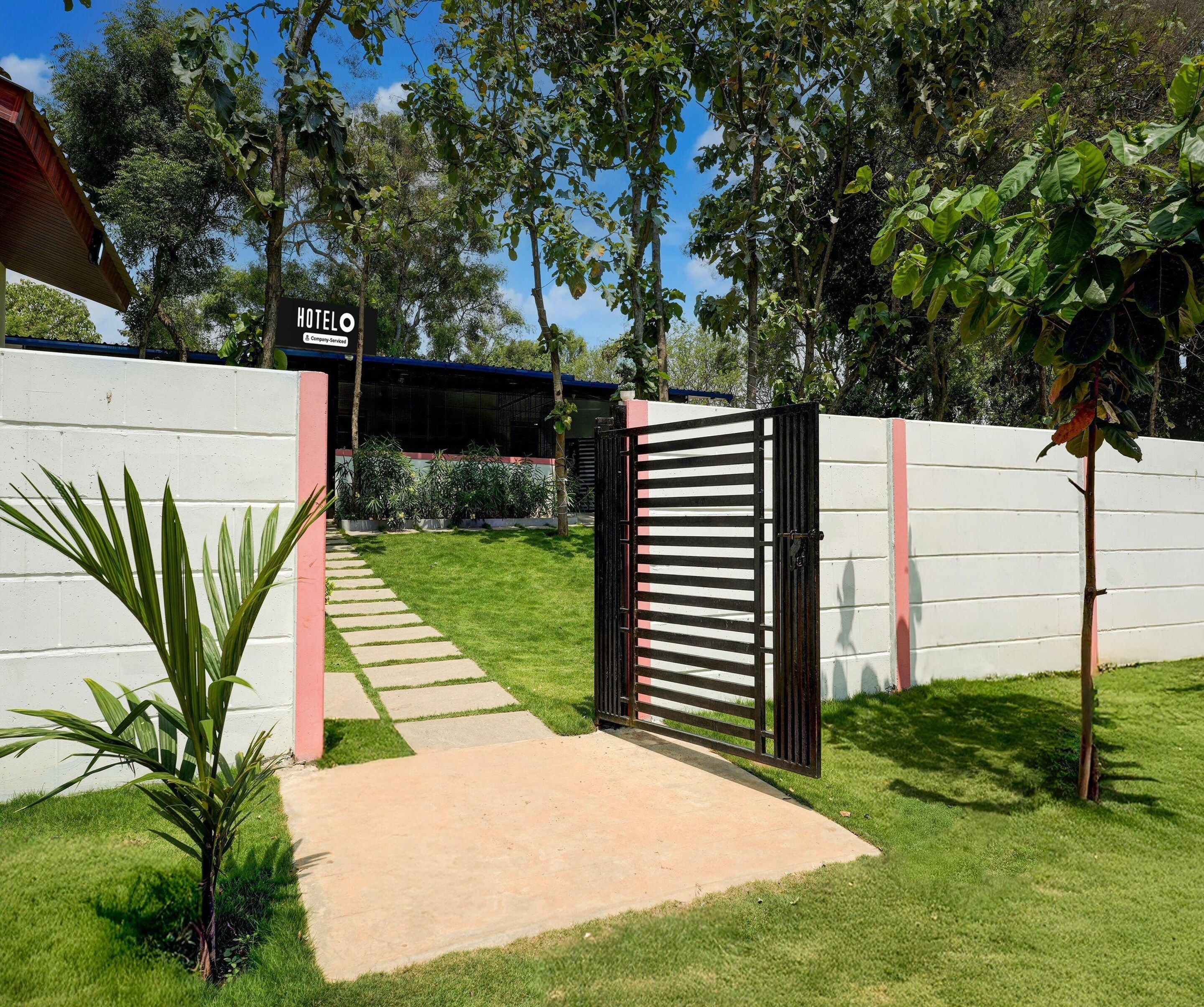 A gated entrance to a property with a sign reading 'HOTEL'.