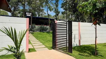 A gated entrance to a property with a sign reading 'HOTEL'.