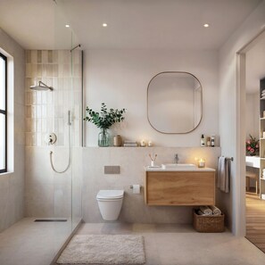 A modern bathroom with a glass shower enclosure, a wooden vanity, a white toilet, and a small rug on the floor. - West Rock Villas (Langebaan)