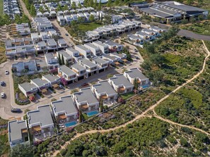 A residential area with modern houses, a swimming pool, and a road. - West Rock Villas (Langebaan)