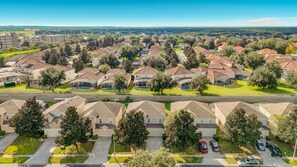 A residential area with multiple houses, a clear sky, and a road. - 6BR Disney Villa, Private Pool/Spa + Resort Access (Kissimmee)