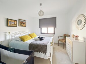 A bedroom with a bed, a dresser, a chair, a window, and wall decorations. - Escape to Arcachon Bay: House near Le Teich Bird Reserve (Le Teich)