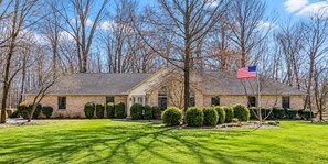 A two-story brick house with a well-maintained lawn and trimmed hedges. - Wooded Acre Retreat near Wright-Patt w/ Game Room (Xenia)