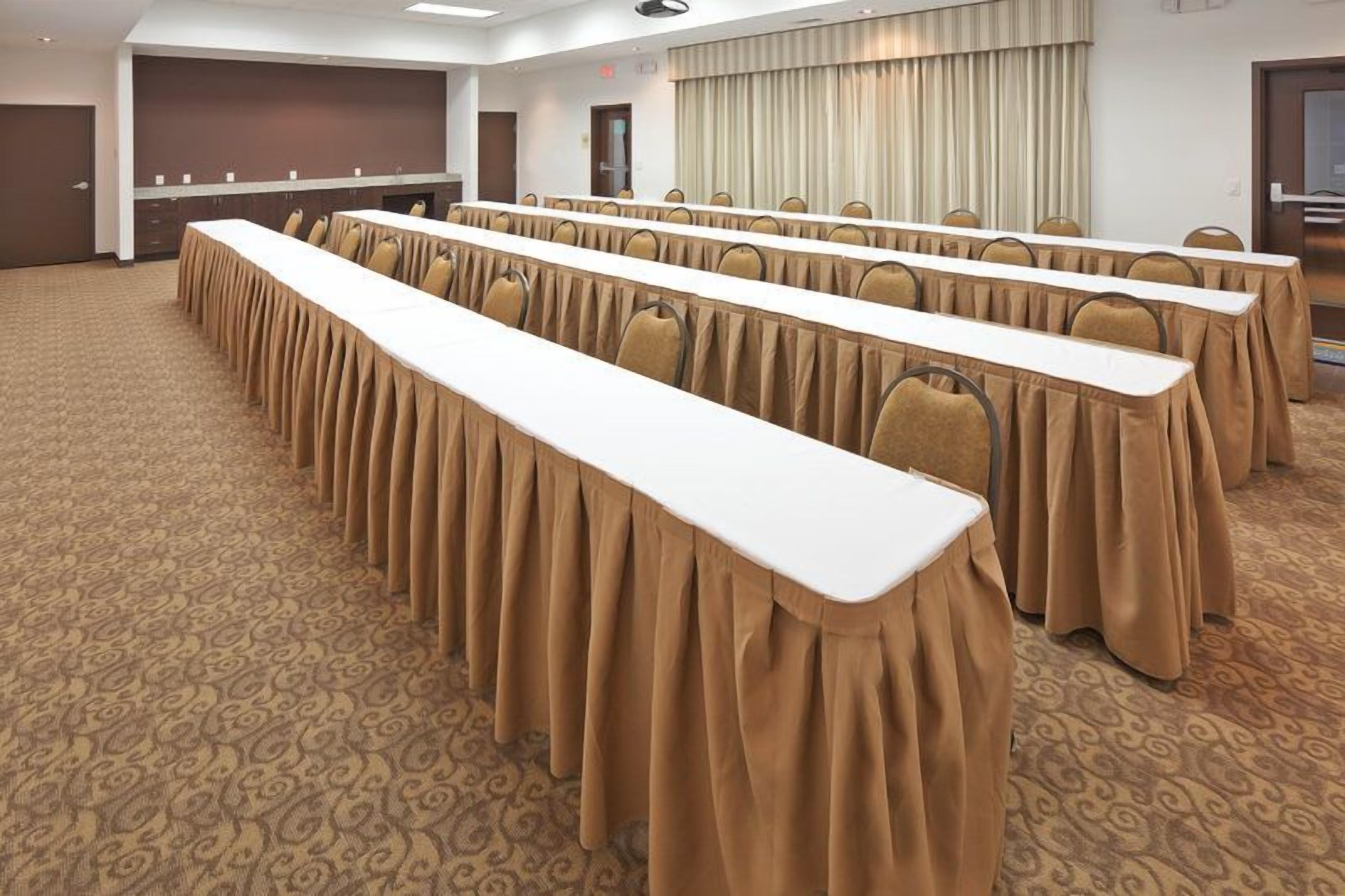 Conference room with long tables, set up for meetings