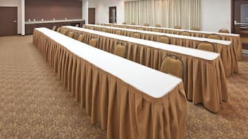 Conference room with long tables, set up for meetings