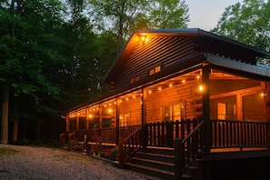 A wooden cabin with a porch, surrounded by trees. - Luna Moth | Hocking Hills, Firepit, Pool Table (Logan)