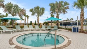 A pool area with lounge chairs and umbrellas, surrounded by palm trees. - Mickey Magic and Harry Potter Pool Retreat (Davenport)