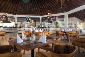 A restaurant with wooden furniture and a high ceiling. - Junior Suite – Beachfront Escape on Cofresí Beach (Puerto Plata)