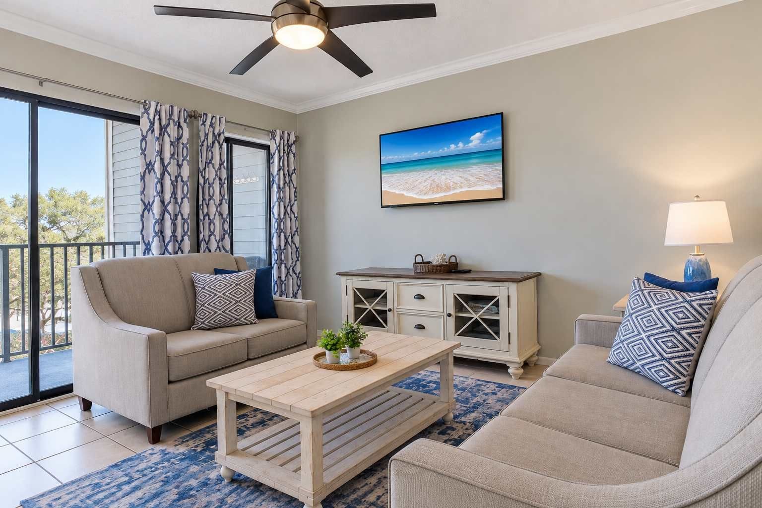 A living room with a sofa, coffee table, and a cabinet. There is a ceiling fan, a window with curtains, and a painting on the wall.