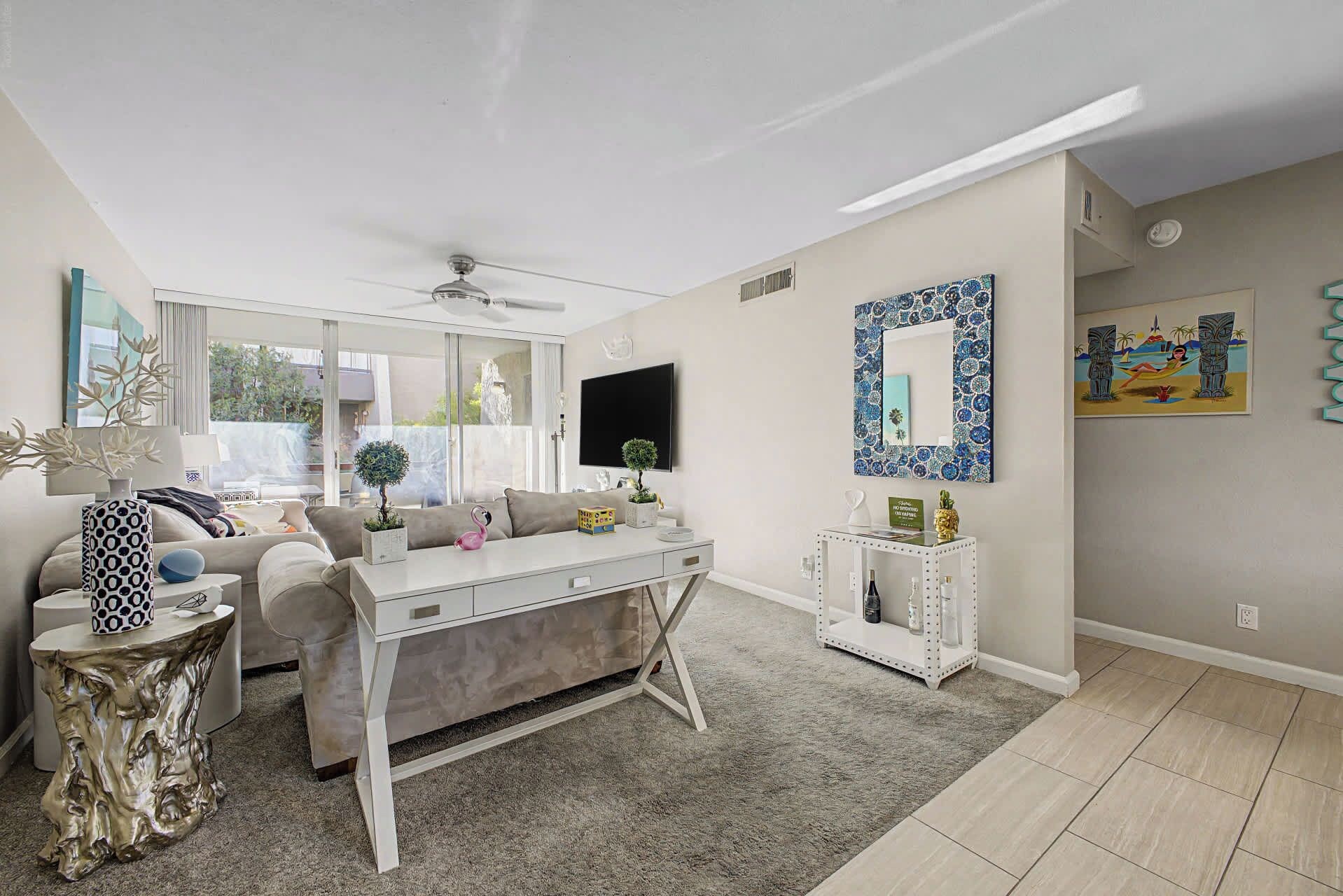A modern living room with a sofa, coffee table, and decorative items.