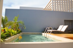 A pool area with lounge chairs and a small water feature. - Hamaca  Calma y Dise  o  Eco-chic Boutique Stay (Playa del Carmen)
