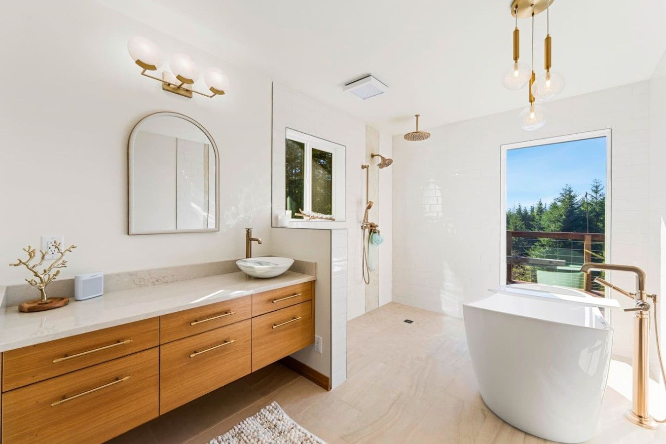 A modern bathroom with a freestanding bathtub, a large mirror, a vanity with a bowl sink, and a shower with a glass enclosure.