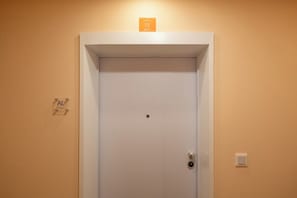 A white door with a lock and a small sign above it. - Excellent Carmo Suite – Stylish Apartment Old Town (Funchal)