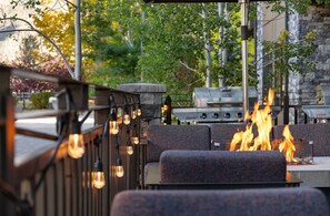 An outdoor seating area with a grill and fire feature. - 3 Bedroom Presidential In Avon, Co (Avon)