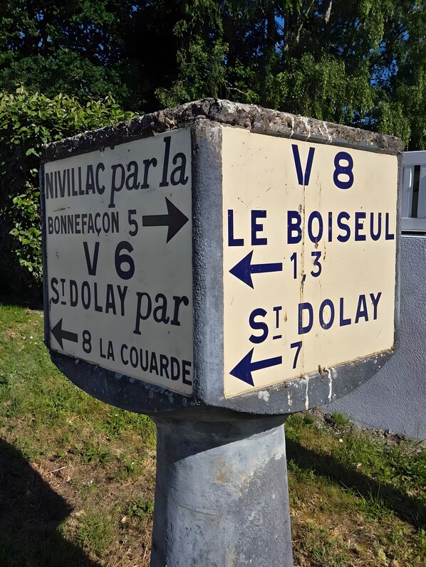 A directional sign with arrows pointing to various destinations.