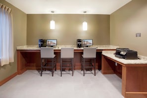 A bar area with three bar stools, two monitors, and a coffee machine. - King Studio w/ Kitchen | Daily Breakfast + Pool (San Antonio)