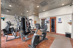 A gym with various exercise equipment, including treadmills and weight machines. - 2BR High Floor Suite | Pool/Sauna | Mountain Views (Sugar Mountain)