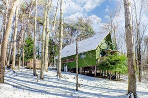 A wooden cabin with a sign reading 'BAIT & TACKLE' surrounded by a snowy forest. - Hillside Haven- a cozy Getaway in the heart of Hocking Hills (Rockbridge- Hocking Hills (Hillside Haven))