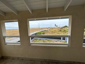 A room with two windows overlooking a road and a distant landscape. - ShaDow Villa - 3 Bedroom House Near Airport (Charnocks)