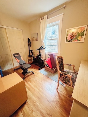 A room with a stationary bike, a chair, and a window with curtains. - Sweet Beach House in the City! Great neighbourhood; family and pet friendly (Toronto)