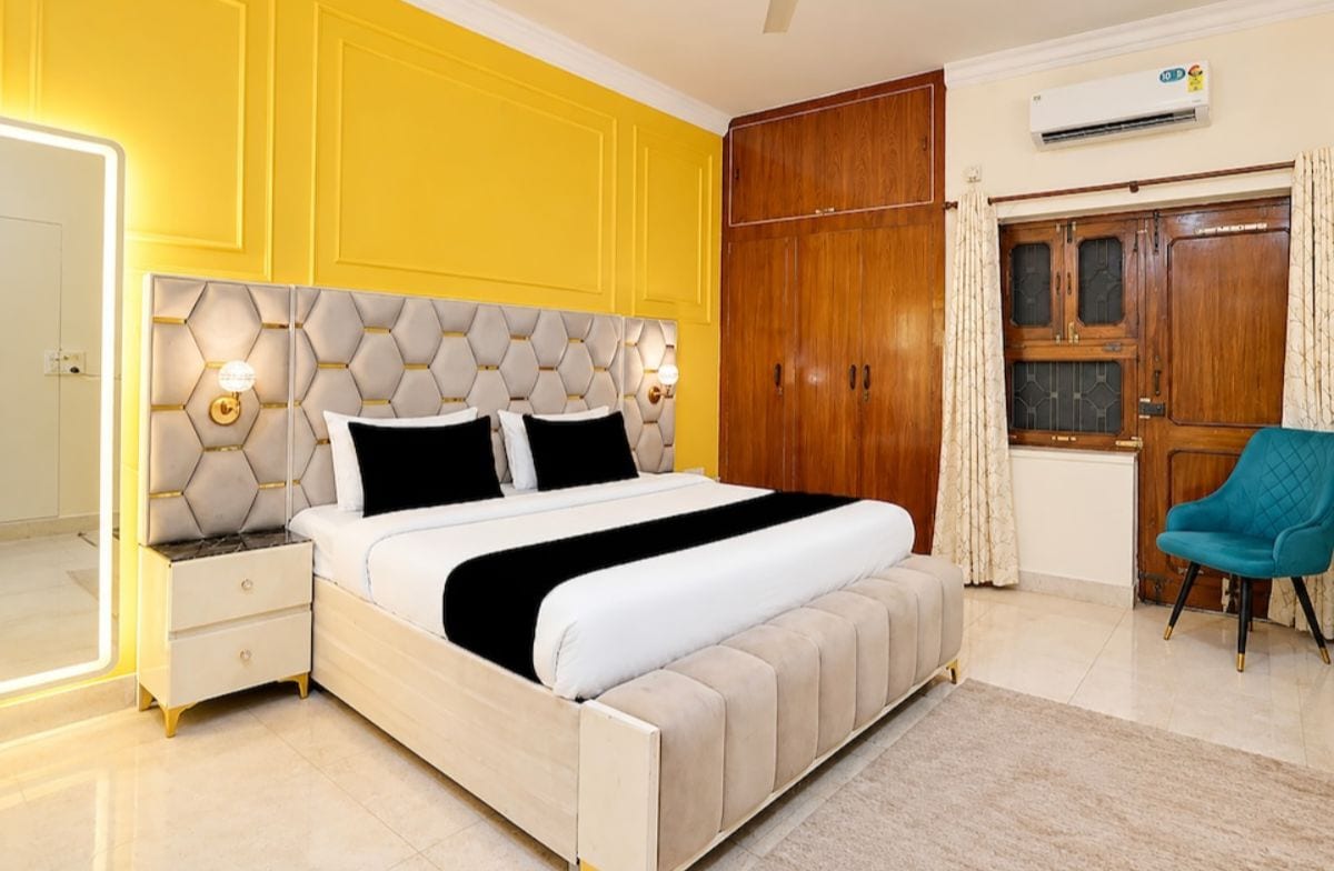 A bedroom with a bed, nightstands, a wardrobe, and a chair.