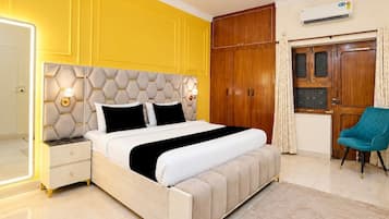 A bedroom with a bed, nightstands, a wardrobe, and a chair.