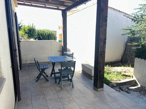 A covered patio area with a table and chairs, a tiled floor, and a view of the surrounding area. - New Listing (Grosseto-Prugna)
