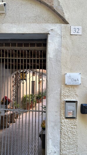 A gated entrance with a number sign, a villa sign, and a security intercom. - New Listing (Orvieto)
