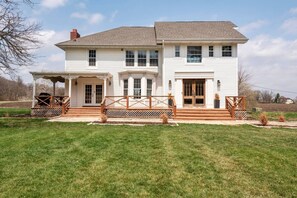 A two-story house with a porch, a covered entryway, and a front yard. - Viral Farmhouse Sensation! 5 million+ views on FB! (Fort Calhoun)