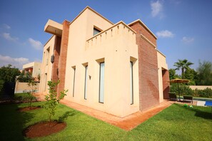 A modern two-story building with a flat roof, large windows, and a brick facade. - New Listing (Marrakech)
