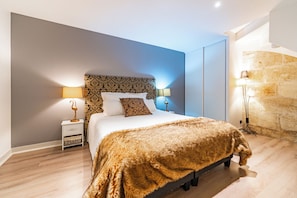 A bedroom with a bed, nightstands, and a lamp. - New Listing (Bordeaux)