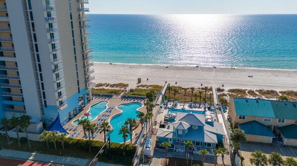 A resort with a swimming pool, beach access, and a view of the ocean. - Gulf Highlands Getaway | 11 Pools + Mini Golf | Sleeps 6 (Panama City Beach)