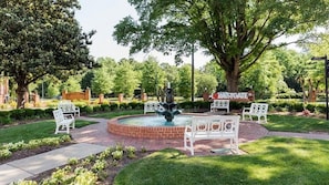 A park with a fountain, benches, and a sign that reads 'WESTGATE'.