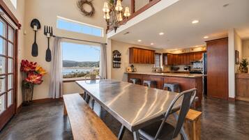 A spacious kitchen with a large island, wooden cabinets, and a view of the outdoors.
