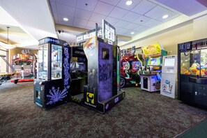 A gaming arcade with various machines, including 'The Walking Dead' and 'RAW'. - Fantasy World Resort, The Lego House - Free Waterpark and free Disney Shuttle (Kissimmee)