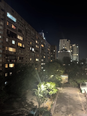 A nighttime view of a multi-story residential building with illuminated windows and balconies. - Cozy 2-bedroom apartment in fabulous Yerevan centre (Yerevan)