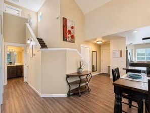 A spacious living area with a staircase, a dining table, and a kitchen area. - Spacious Midtown Home, Walk to Lake & Downtown (Coeur d'Alene)