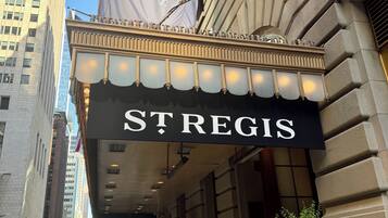 A theater marquee with the name 'ST REGIS' and a classical architectural facade.