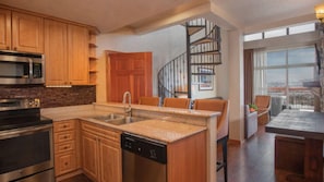 A modern kitchen with a built-in island, stainless steel appliances, and a dishwasher. - Westgate Park City 4BR Villa - Private Hot Tub Balcony, Ski-In/Ski-Out (Park City)
