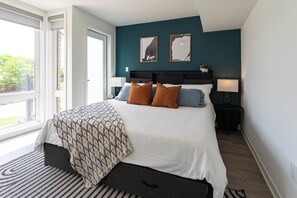A modern bedroom with a large bed, bedside lamps, and a view of the outdoors. - Skip Downtown Traffic! Pristine 3BR, steps to Yorkdale/TTC (Toronto)
