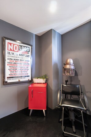 A corner of a room with a framed poster on the wall, a red cabinet, and a black chair. - New Listing (Tibau do Sul)