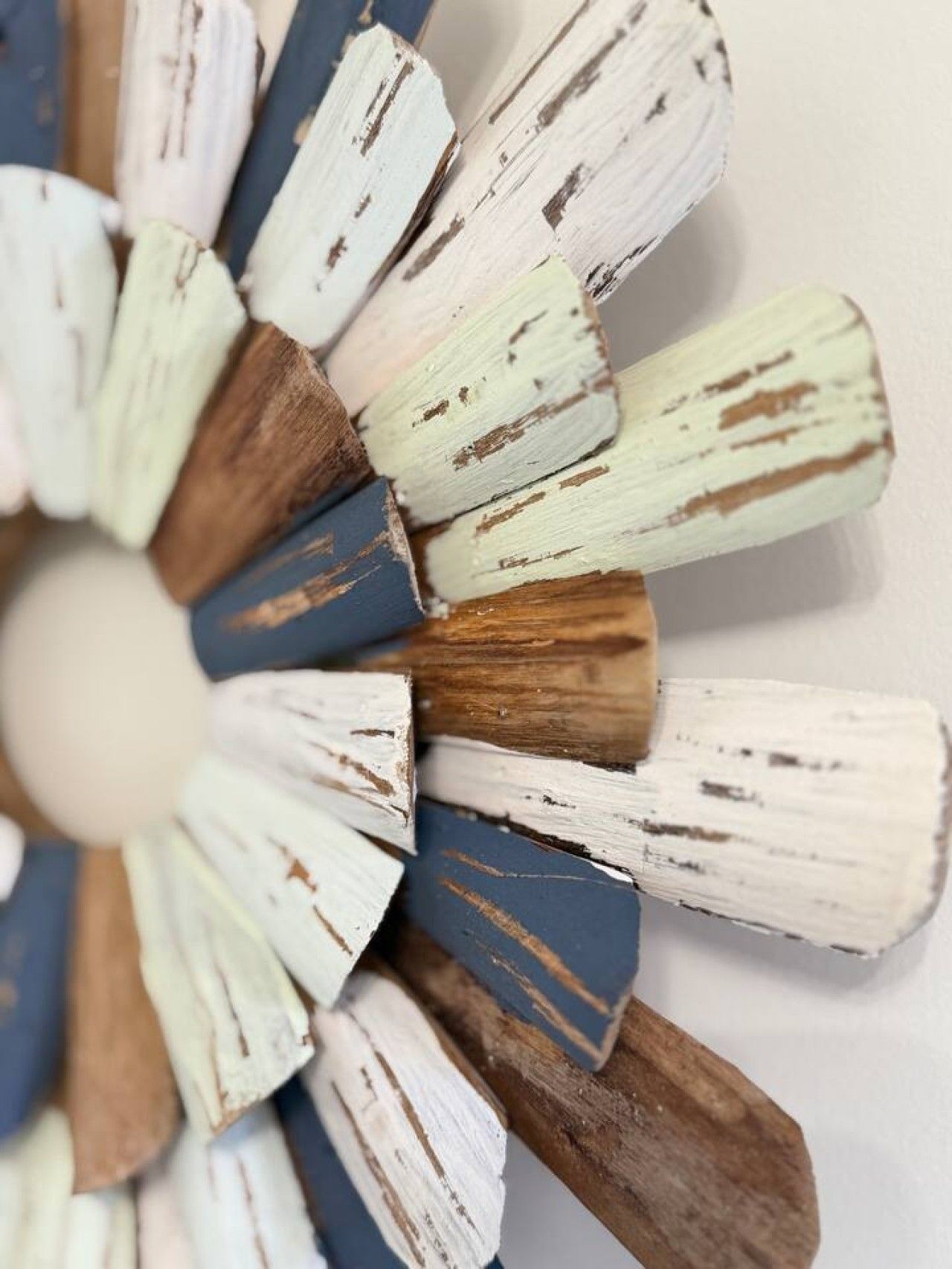 A circular object with a central hole, surrounded by wooden elements with varying textures and colors.