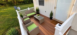 A deck with wicker furniture and potted plants. - Evermore Residence • Private Home • Sleeps 3 (Roanoke)