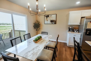 A modern kitchen with a marble countertop, a built-in stove, and a refrigerator. - 4 BR | 3 BA | New Build | 3-Car Garage | 5 Beds (Omaha)